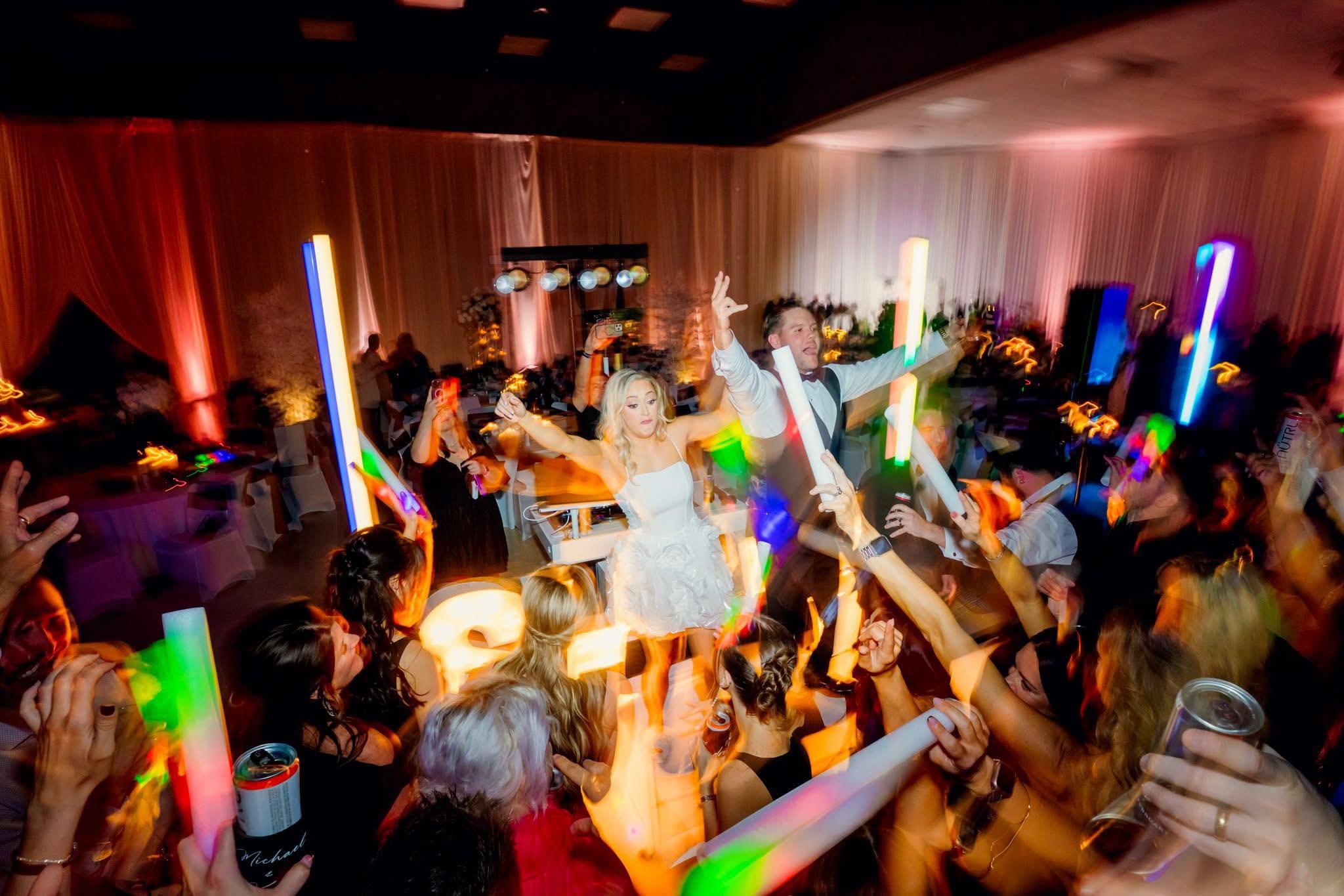 Packed dance floor with glow sticks